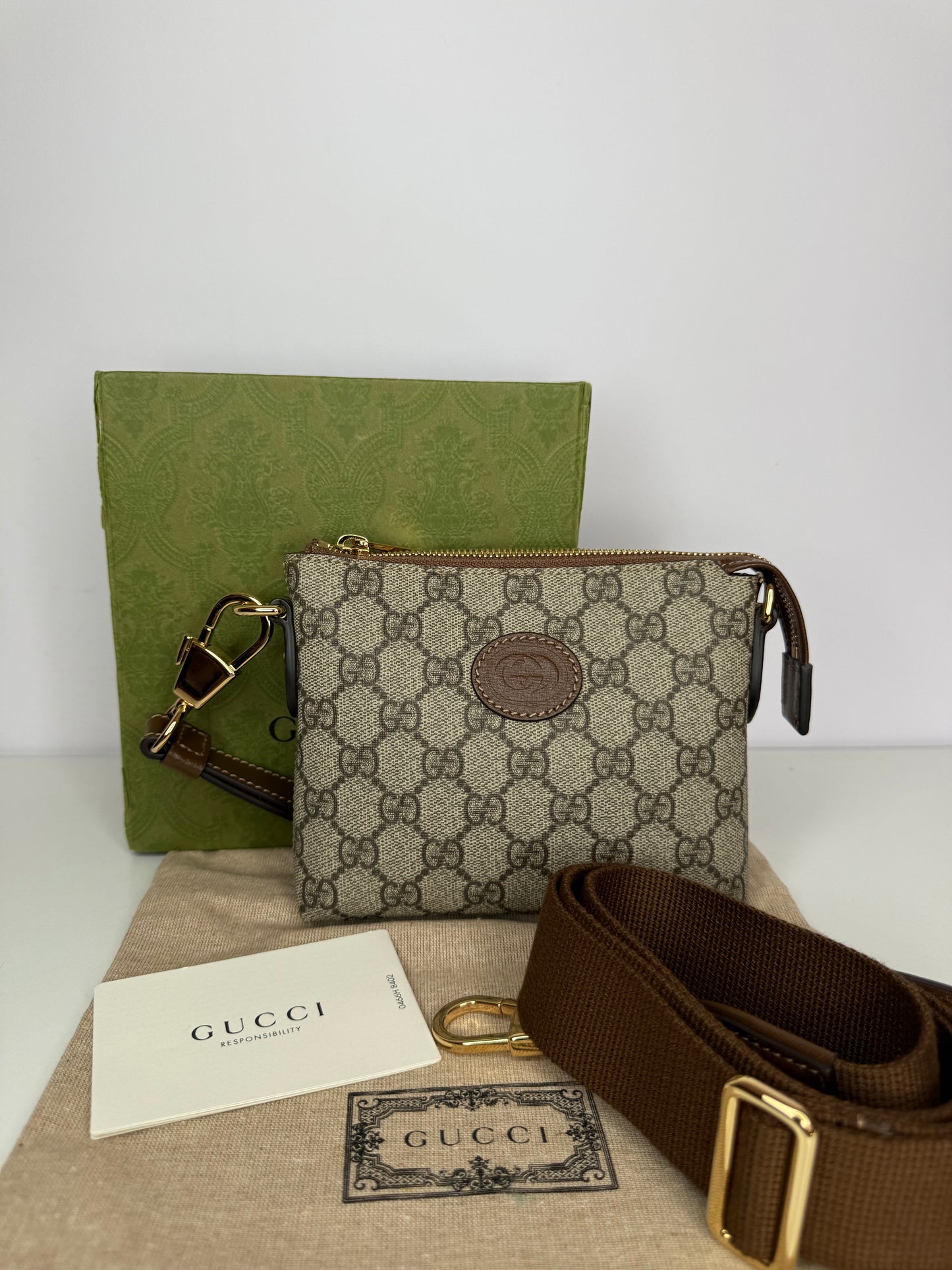 Gucci GG Coated Canvas Interlocking G Patch Wristlet Mini Messenger Bag